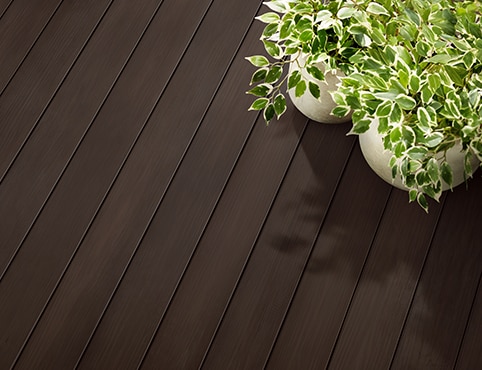 A deck stained with Cordovan Brown ES-62 Semi-Solid Woodluxe® Exterior Stain.
