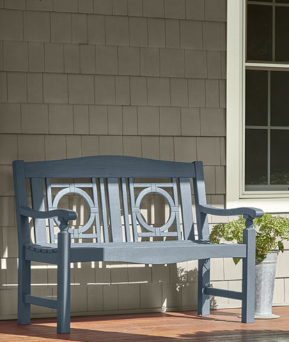 Vinyl siding home exterior with white-painted trim and a blue-gray bench Vinyl siding home exterior with white-painted trim and a blue-gray bench