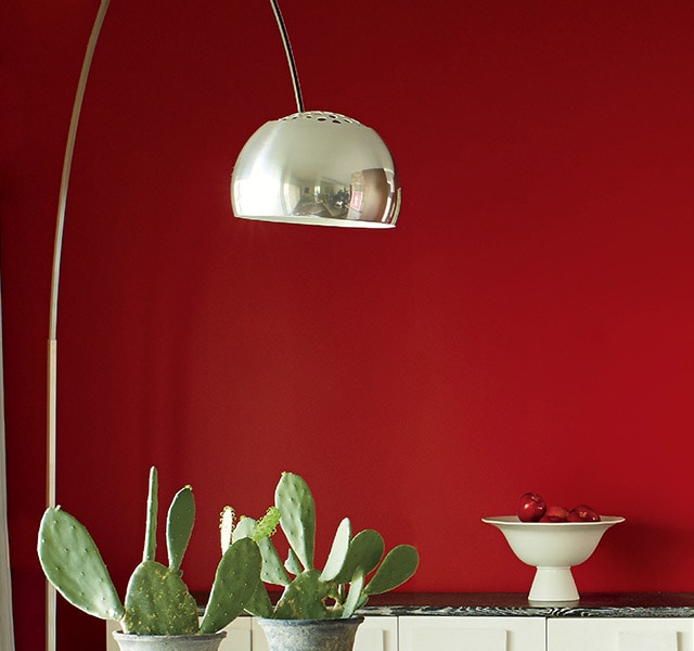 A contemporary dining room with a red accent wall. A contemporary dining room with a red accent wall.