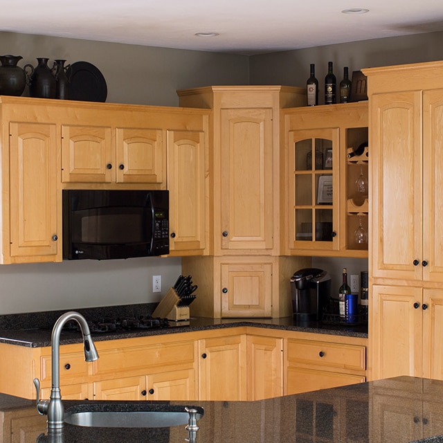 A Kitchen with wood cabinets, black countertops and appliances before a makeover. A Kitchen with wood cabinets, black countertops and appliances before a makeover.