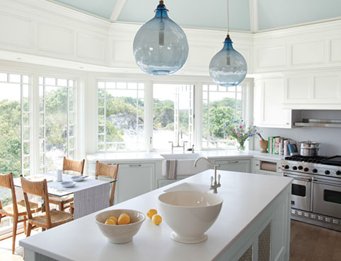 Bright, airy light blue kitchen with center island and cliffside view. Bright, airy light blue kitchen with center island and cliffside view.