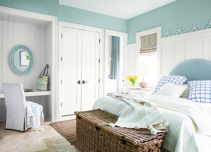 A light-blue painted bedroom with white trim and built-in vanity area. A light-blue painted bedroom with white trim and built-in vanity area.