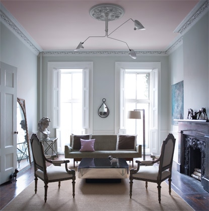 A living room in a blue gray paint is accented by a pale pink ceiling. A living room in a blue gray paint is accented by a pale pink ceiling.