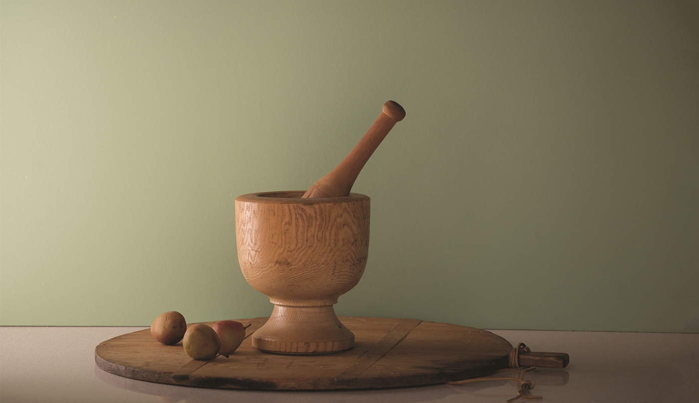 Fernwood green wall with wood mortar and pestle set on a lazy susan.
