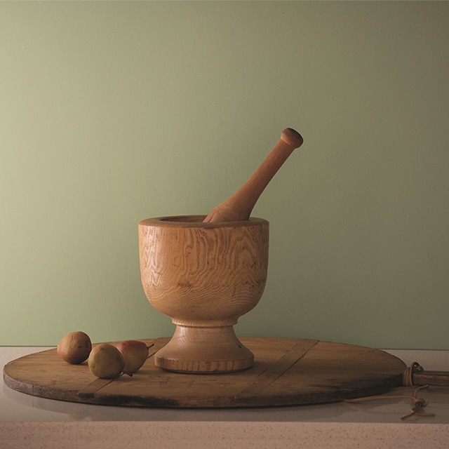 Fernwood green wall with wood mortar and pestle set on a lazy susan.