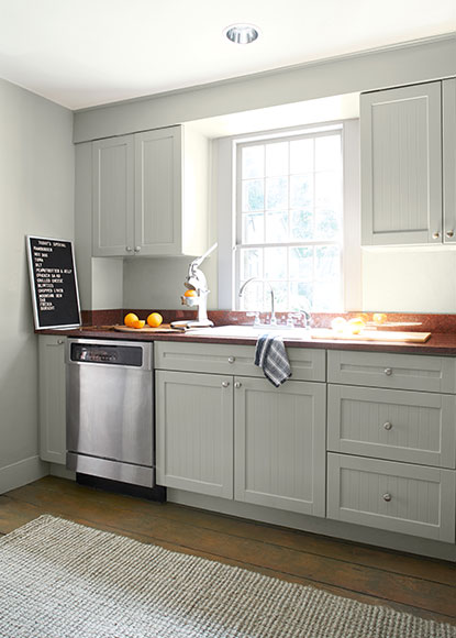An airy kitchen with walls, cabinets and trim painted in Titanium OC-49, a light greige. An airy kitchen with walls, cabinets and trim painted in Titanium OC-49, a light greige.