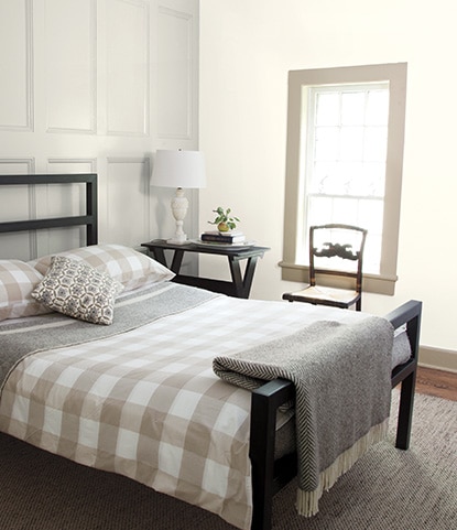 A white bedroom with panelled walls painted in Classic Gray OC-23. A white bedroom with panelled walls painted in Classic Gray OC-23.
