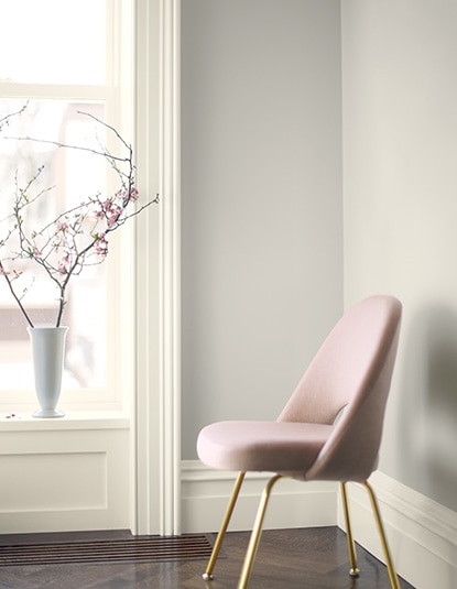 A pink chair frames a wall painted in Balboa Mist OC-27. A pink chair frames a wall painted in Balboa Mist OC-27.
