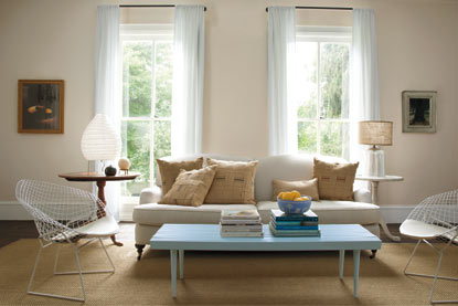 Open modern living room with light neutral walls and mixed-style furnishing Open modern living room with light neutral walls and mixed-style furnishing