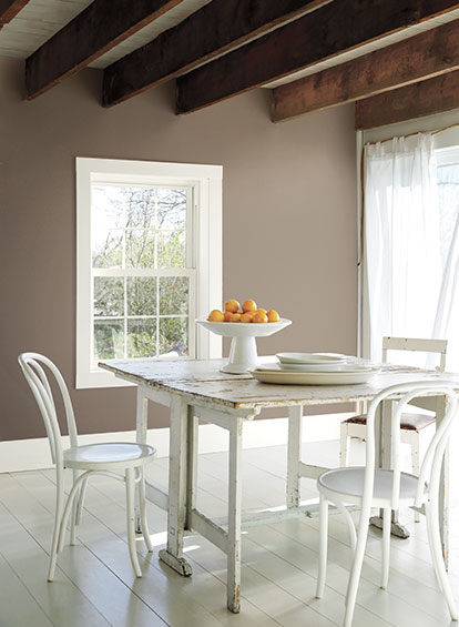 A dining area with exposed ceiling beams and walls painted in Weimaraner AF-155. A dining area with exposed ceiling beams and walls painted in Weimaraner AF-155.