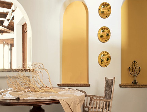 An elegant dining area in yellow wall accents. An elegant dining area in yellow wall accents.