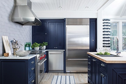 Sunny, modern kitchen with blue cabinetry and stainless steel appliances. Sunny, modern kitchen with blue cabinetry and stainless steel appliances.