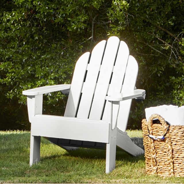 Wood Adirondack chairs painted in a white paint color. Wood Adirondack chairs painted in a white paint color.