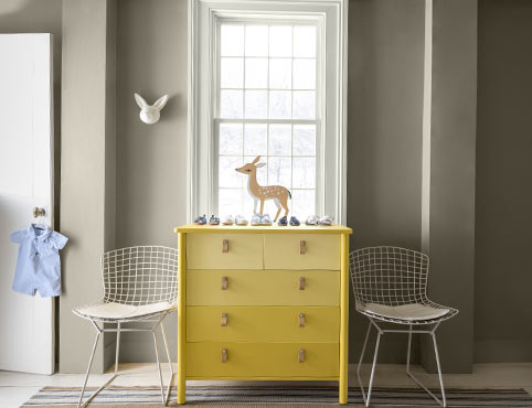 Sunshine yellow dresser in gray kid’s room. Sunshine yellow dresser in gray kid’s room.