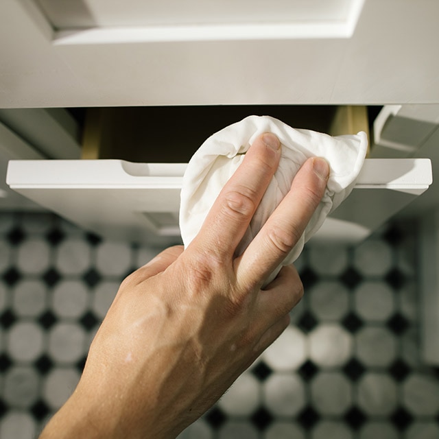 Cleaning the bathroom vanity with a damp cloth. Cleaning the bathroom vanity with a damp cloth.