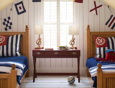 Nautical bedroom with white shiplap walls and two twin size beds. Nautical bedroom with white shiplap walls and two twin size beds.