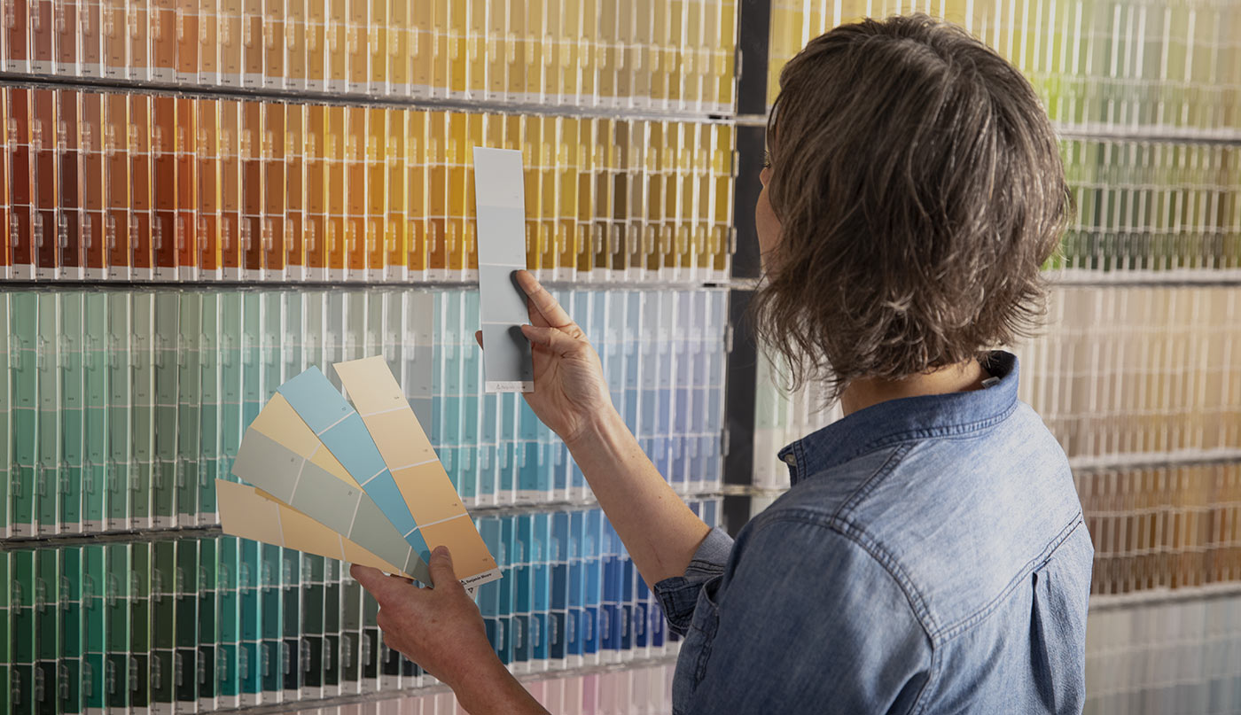 Woman inspecting various paint swatches.