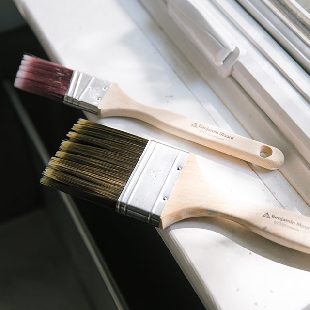 Two dried and clean paintbrushes in front of a window. Two dried and clean paintbrushes in front of a window.