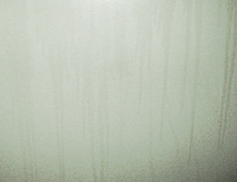 A close-up that shows surfactant leaching on a wall. A close-up that shows surfactant leaching on a wall.