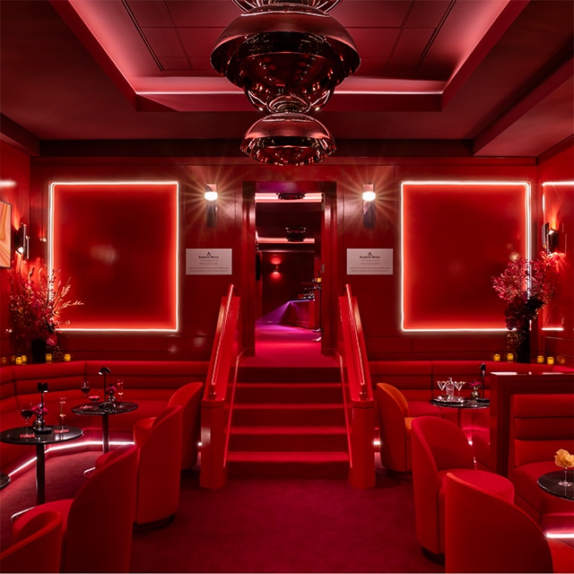 Benjamin Moore’s red-painted hospitality lounge at Madison Square Garden with red lighting.  