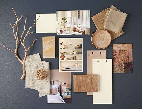 White and neutral paint chips, home interior photos and other natural accents lay atop a navy blue-painted surface. White and neutral paint chips, home interior photos and other natural accents lay atop a navy blue-painted surface.